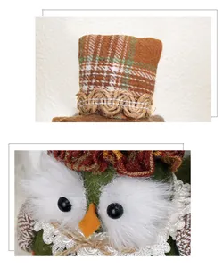 Macro detail of fabric owl ornament showing plaid hat, lace trim, and faux fur texture