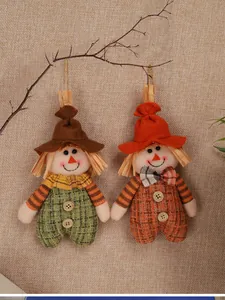Detail of two handmade scarecrow fabric pendants with rustic jute and button accents