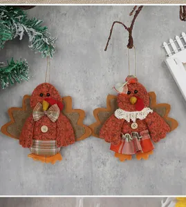 Detail of hanging turkey plush ornaments with knitted fabric and lace for harvest decor
