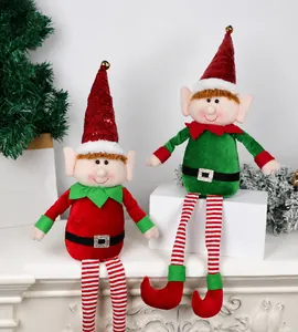 Detail view of red and green plush Christmas elves with sequin hats and striped legs