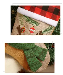 Close-up of Christmas stocking fabric featuring reindeer embroidery and plaid trim detail