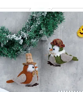Detail of two handmade felt owl hanging decorations with harvest festival plaid hats and lace