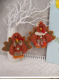 Detail of plush Thanksgiving turkey ornaments hanging on branches for festive home decor