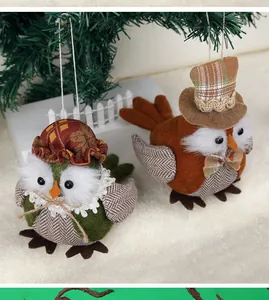 Detail of owl holiday ornaments with festive hats and white plush artificial fur trim