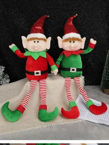 Close-up of red and green Christmas elf dolls with striped legs and sequined hats