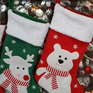Christmas stockings featuring reindeer and polar bear designs with white plush cuffs
