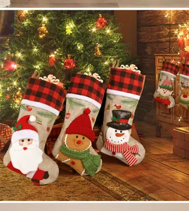 Detail of Christmas stockings with Santa and Snowman figures by a cozy fireplace