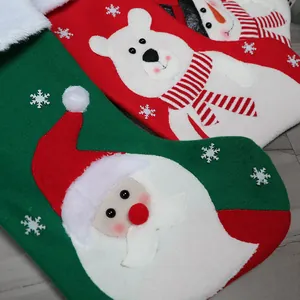 Large Christmas stockings featuring 3D Santa, Snowman and Polar Bear on festive wooden background