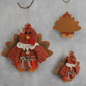 Three plush Thanksgiving fabric turkey hanging ornaments with lace details and golden cords