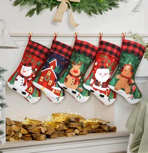 Detailed view of five festive Christmas stockings hanging on a rustic warm fireplace