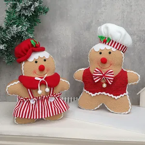 Standing plush gingerbread dolls in Christmas outfits for festive tabletop decoration