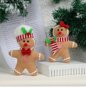 Detailed view of plush gingerbread man Christmas ornaments with chef hat and scarf