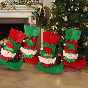 Set of four Christmas elf stockings with bells hanging by a cozy festive fireplace