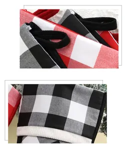 Close-up of red and black buffalo plaid Christmas stocking fabric and sturdy hanging loop