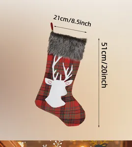 Detail of red and black plaid Christmas stocking with white reindeer and faux fur trim