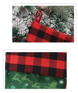 Detail of green Christmas stocking with reindeer prints and red-black buffalo plaid cuff