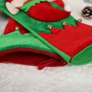 Classic red and green elf Christmas stocking with golden bells on white lace background