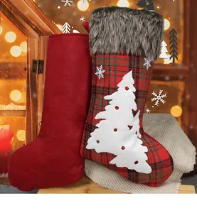 Detail of red and plaid Christmas stockings with faux fur trim and snowflake embroidery