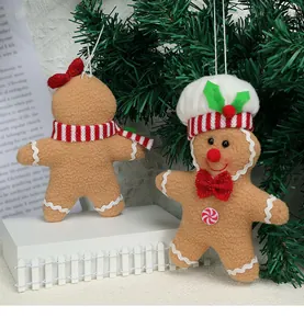 Close-up of plush gingerbread man Christmas tree ornaments with festive scarves and chef hats