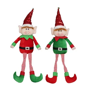 Pair of Christmas plush elf dolls with long striped legs and sequined hats on white background