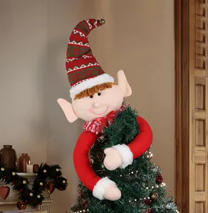 Detailed view of a Christmas elf tree topper with festive red and green striped hat