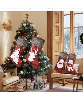 Detailed close-up of plaid Christmas stockings with faux fur trim and holiday appliques