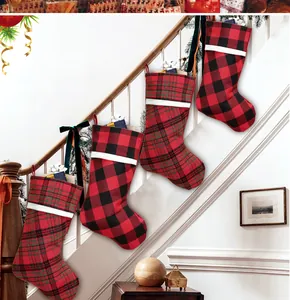 Detailed view of 4-piece Christmas stockings set with plaid patterns hanging on stairs