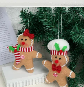 Detail of felt gingerbread man ornaments with chef hat and scarf for Christmas decor