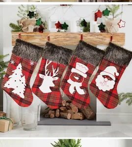 Detailed view of four plaid Christmas stockings hanging from a festive fireplace mantle