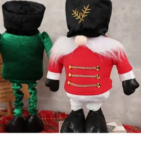 Detail of plush nutcracker gnomes with gold embroidery and velvet hats for Christmas decor