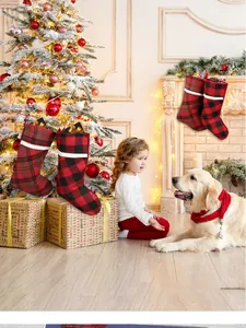 Close-up of red and black buffalo plaid Christmas stockings with white faux fur trim
