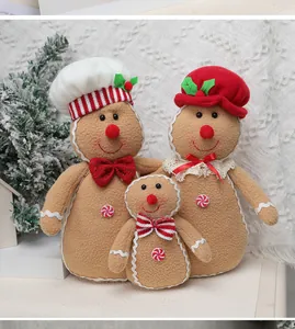 Set de tres peluches de hombre de jengibre con gorros y adornos navideños festivos