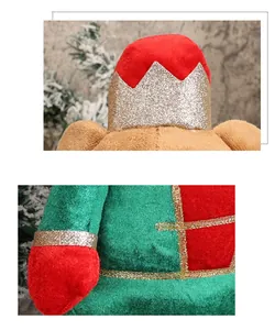 Detail of plush Christmas bear with golden glitter crown and red velvet festive clothes
