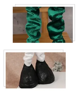Detailed view of plush doll legs in green velvet with black faux leather boots and fur trim