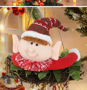 Close-up of Christmas elf plush ornament with red snowflake hat and green leaves decor