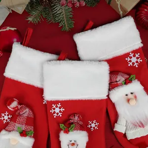 Three-piece set of red plush Christmas stockings with Santa, Snowman and Gnome figurines