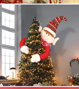 Detailed view of plush Christmas elf tree topper with striped hat and long arms