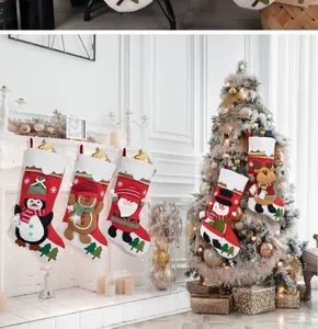 Set of 5 Christmas stockings featuring Santa, Snowman, and Reindeer hanging on a fireplace