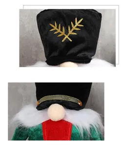 Detailed view of plush velvet Santa soldier hat with gold sequins and jewel embellishments