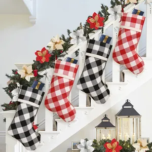Set of four red and black buffalo plaid Christmas stockings on festive mantle