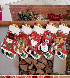 Detail of five assorted Christmas stockings with plush trim hanging in a festive setting