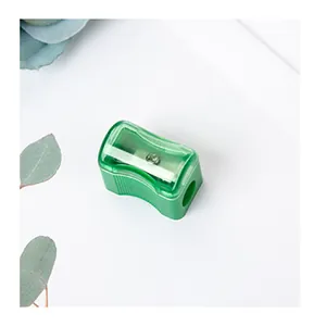 Mini green translucent pencil sharpener with manual single hole and floral decor