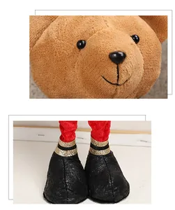Macro view of plush Christmas bear head and legs with red trousers and golden glitters
