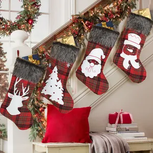 Set of 4 checkered Christmas stockings with plush trim hanging on stairs decoration