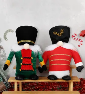 Close-up of plush Christmas gnomes dressed as Nutcracker soldiers on a wooden shelf