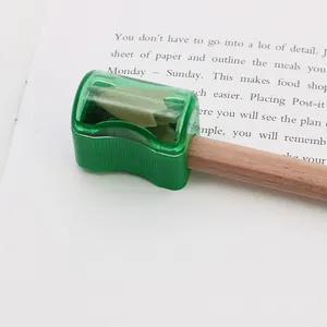 Mini bread pencil sharpener in translucent green plastic with built-in waste container