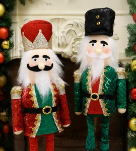 Detail of Christmas nutcracker soldier dolls with sequins and plush fabric on fireplace