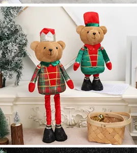 Close-up of plush Christmas bears in plaid coats and crowns on a festive fireplace