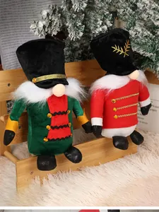 Detail of red and green Christmas gnomes with golden sequins sitting on a wooden bench