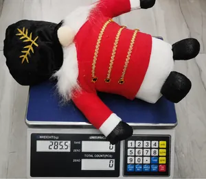 Detailed view showing a Nutcracker Gnome plush toy being weighed on a scale at 285.5 grams